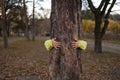 Female hands hugging tree bark in autumn park. Royalty Free Stock Photo