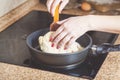 Female hands inverted pie in pan