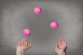 Female hands juggle colorful eggs.