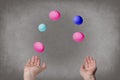 Female hands juggle colorful eggs.