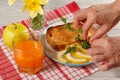 Female hands lay down breakfast food on a plate. Toast with Royalty Free Stock Photo