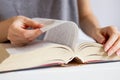 Female hands leafing through pages of books. Closeup open book, reading concept background. Turn the page of the book Royalty Free Stock Photo