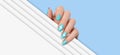 Female hands with light blue manicure nails, hearts design