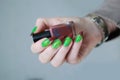 Female hands with long nails and green and brown manicure Royalty Free Stock Photo