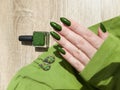 Female hands with long nails with green nail polish Royalty Free Stock Photo