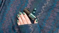 Female hands with long nails with green nail polish Royalty Free Stock Photo