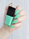 Female hands with long nails with green nail polish Royalty Free Stock Photo