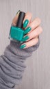 Female hands with long nails with green nail polish Royalty Free Stock Photo