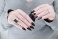 Female hands with long nails and total black manicure Royalty Free Stock Photo