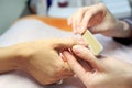 Female hands make manicure by nailfile for woman Royalty Free Stock Photo