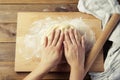 Female Hands Making Dough for baking pie, or pizza. Homemade Preparing Food. Top view. Rustic background. Royalty Free Stock Photo