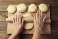 Female Hands Making Dough for baking pie, or pizza. Homemade Preparing Food. Top view. Rustic background. Royalty Free Stock Photo