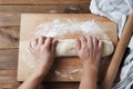 Female Hands Making Dough for baking pie, or pizza. Homemade Preparing Food. Top view. Rustic background. Royalty Free Stock Photo