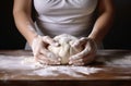 Female hands making dough. Hands kneading bread dough on a cutting board Royalty Free Stock Photo