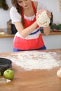 Female hands making dough for pizza or bread on wooden table. Baking concept Royalty Free Stock Photo