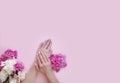 Female hands manicure flower peony on a colored background Royalty Free Stock Photo