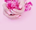 Female hands manicure style flower peony glamour on a pink background Royalty Free Stock Photo