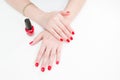 Female hands with manicure and red lacquer on a white table in the beauty salon. closeup of hand of a young woman. Royalty Free Stock Photo