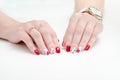 Female hands with manicure, red nail polish, drawing with cherries. White background. Royalty Free Stock Photo