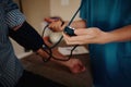 Closeup of young female doctor hands measuring patient blood pressure Royalty Free Stock Photo