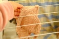 Female hands of middle-aged woman close-up hang wet washed linen, bra on wire dryer, gentle hand washing of lacy underwear, Royalty Free Stock Photo