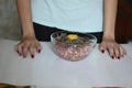 Female hands mix minced meat on cutlets Royalty Free Stock Photo