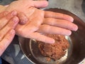 female hands mixing minced meat and make meatballs
