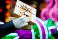 Female hands opening gift box with a bow at the blurred bokeh ba Royalty Free Stock Photo