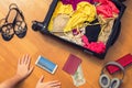 Female hands with passport Asian money and American hundred dollar bills. Suitcase with things on the floor. Choosing and exchange Royalty Free Stock Photo