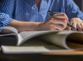 Female hands with pen closeup writing in notebook, taking notes, studying Royalty Free Stock Photo