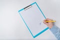 Female hands with pen on document. Woman puts signature on paper. Top view Royalty Free Stock Photo