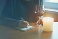 Female hands with pen and glass of wine writing Royalty Free Stock Photo