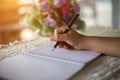 Female hands with pen writing on notebook coffee cafe