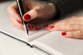 Female hands with pen writing on notebook. Diary, plans, journalist