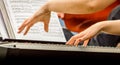 Female hands of a pianist musician and piano keys close up