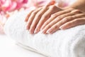 Female hands placed on a soft white towel ready for nails to be done in a manicure spa Royalty Free Stock Photo