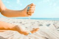 Hands playing with sand on beach. Royalty Free Stock Photo