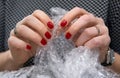 Female hands popping the bubbles in bubble wrap