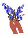 Female hands with posy of delphinium. Woman holds elegant bouquet of meadow plants with blue petals. Beautiful blossom