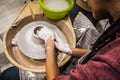 Female hands of a potter. Potter making ceramic pot on the pottery wheel. Concept for woman in freelance, business, hobby Royalty Free Stock Photo
