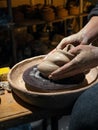 The female hands of a potter work with soft.