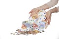 Female hands pour out euro banknotes and coins. Hands attract and magnetize money. Concept of throwing away, devaluing money