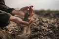 Female hands pouring a black soil in the field. Female agronomist testing a quality of soil. Concept of agriculture. Royalty Free Stock Photo