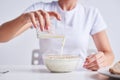 Female hands pouring milk into a cereal Royalty Free Stock Photo