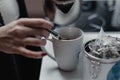 Female hands pouring water from the kettle