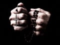 Female hands praying holding a rosary with Jesus Christ in the cross or Crucifix Royalty Free Stock Photo