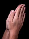 Female hands praying with palms together. Black background. Royalty Free Stock Photo