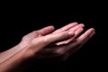 Female hands praying with palms up arms outstretched. Royalty Free Stock Photo