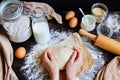 Female hands preparing dough in the kitchen. Baking ingredients on the wooden table Royalty Free Stock Photo