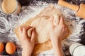 Female hands preparing dough in the kitchen. Baking ingredients on the wooden table Royalty Free Stock Photo